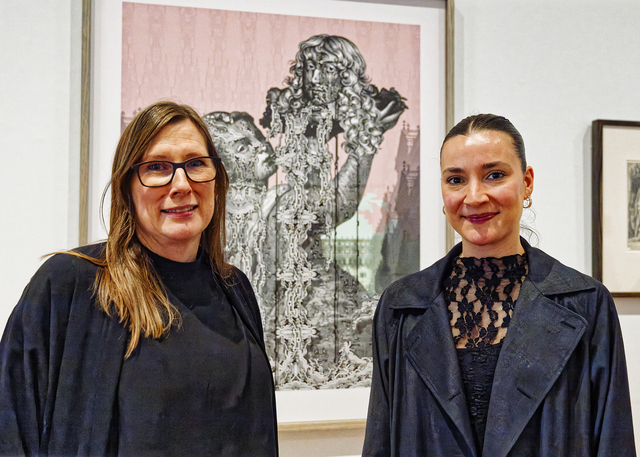 Geelong Gallery curatorial assistant director Lisa Sullivan and assistant curator Lana De Lorenzi with 'Served bold' from the After Image exhibition. (Ivan Kemp)